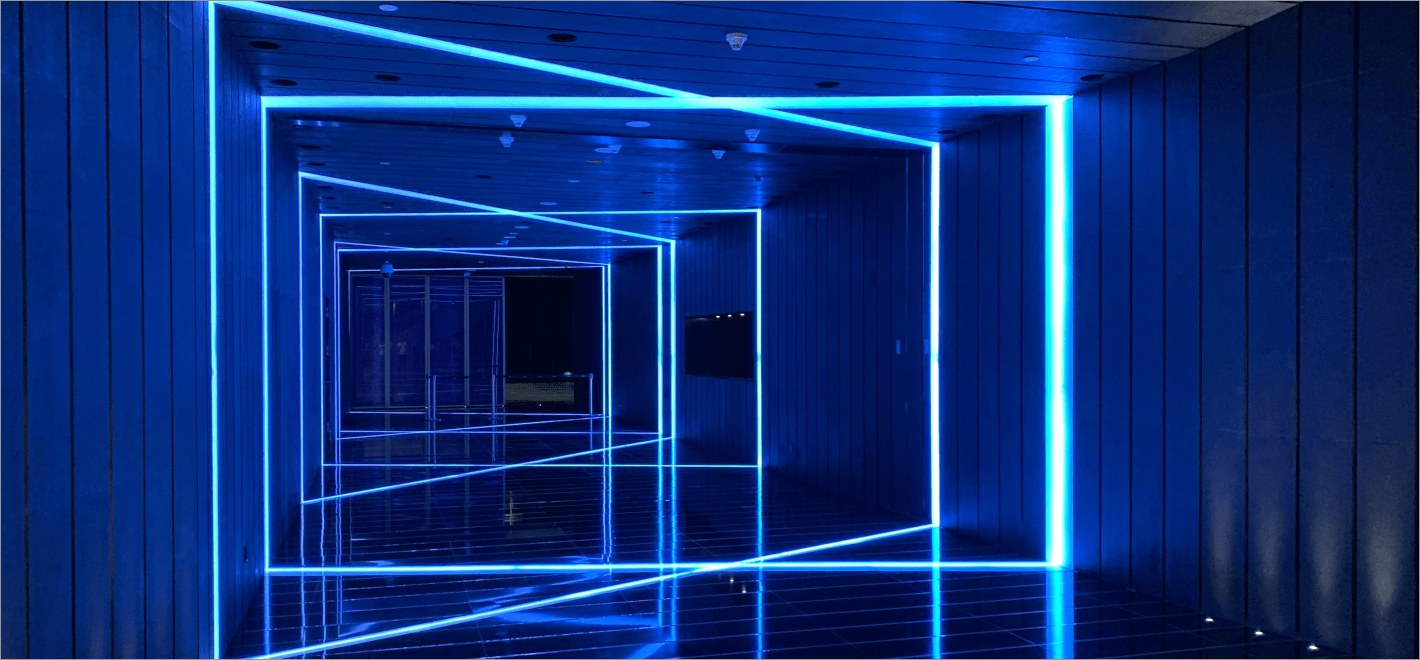 Blue-lit architectural corridor with linear LED lighting